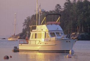 Sunrise lights up this older powerboat. Photo/Joe Devenney camden-jd-powerboat-on-mooring