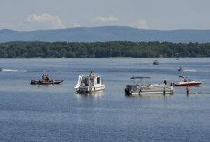 Boaters gather on the shallow sandbar near the Mosquito Bridge. winnisquam-nh-kb-many-types-boats