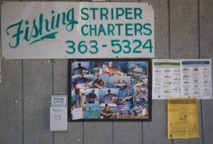 A sign for Shearwater Charters touts the fishing options off York. york-jd-charter-board