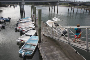A young boy heads own to meet his father as they head out on the water. york-jd-heading-out
