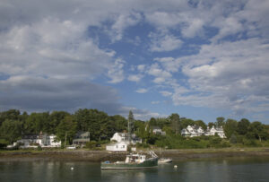 Beautiful homes line the shore. york-jd-lobster-boat-traveling