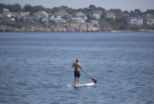 A man takes on the York River aboard his SUP. york-jd-paddler