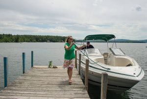 Hannah Seibel helps Rick Murray with his lines as he pulls up to the town docks. wolfeborough-kb-tie-up