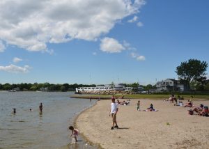 Children frolic in the shallows of the Warren Town Beach on Water Street. warren-az-beach-700x500