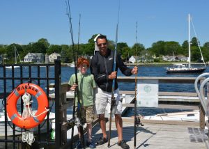 A father and son are all ready for a day on the water. warren-az-father-son-heading-out-to-fish-700x500