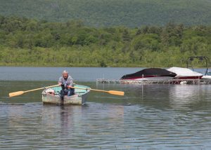 A man heads out on the lake. litchfield-lakes-cd-rowing
