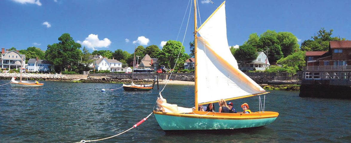 Budding sailors prepare for a lesson aboard a classic 12 1/2 at the Herreshoff Museum.