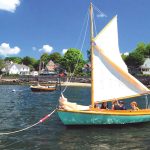 Budding sailors prepare for a lesson aboard a classic 12 1/2 at the Herreshoff Museum.