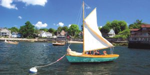 Budding sailors prepare for a lesson aboard a classic 12 1/2 at the Herreshoff Museum.