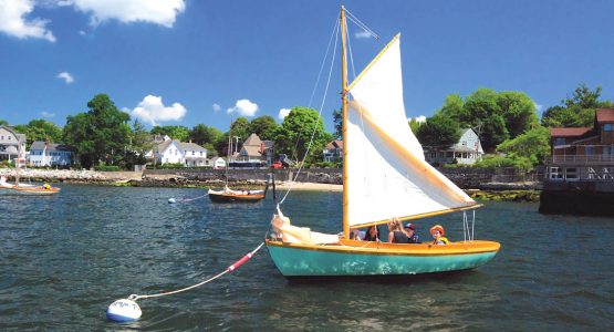 Budding sailors prepare for a lesson aboard a classic 12 1/2 at the Herreshoff Museum.