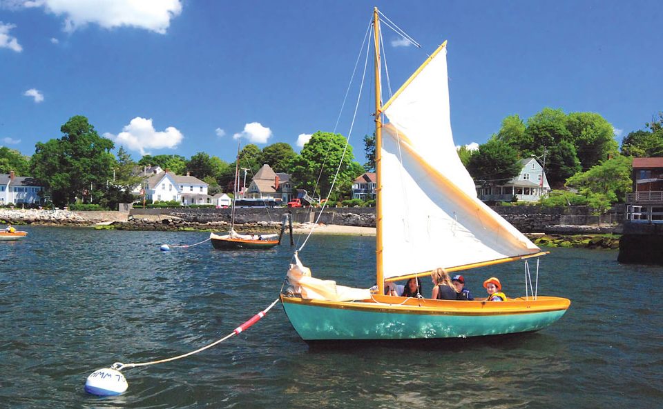 Budding sailors prepare for a lesson aboard a classic 12 1/2 at the Herreshoff Museum.